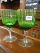A large pair of green glass goblets.