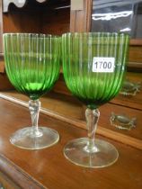 A large pair of green glass goblets.