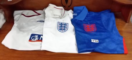 Three official England football shirts.