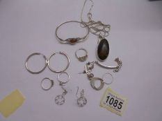 A mixed lot of silver jewellery including an amber pendant, amber set bracelet, rings, earrings etc