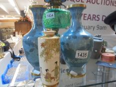 A pair of Japanese cloissonne' vases and a Japanese enamel vase.