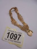 A 9ct gold bracelet with padlock, 5.75 grams.