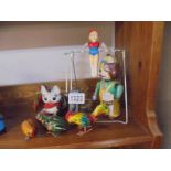 A selection of tinplate clockwork toys including cat, gymnast, newspaper seller etc.,.