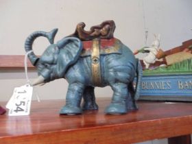 A novelty cast iron elephant money box.