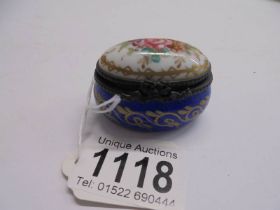 A fine 19th century hand painted porcelain patch box with crossed swords mark, 5 x 3 cm.