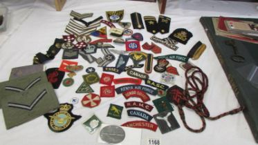 A large collection of military and other cloth badges including Kenya air force, honor guard, scouts