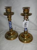 A pair of good quality Victorian brass candlesticks with unusual blue and white ceramic columns.
