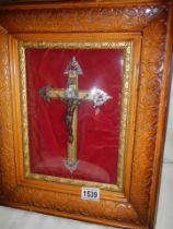 An early 20th century framed and glazed crucifix with domed glass.