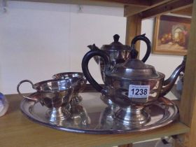 A four piece silver plate tea set on tray.