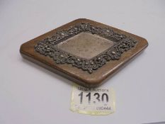 A silver diamond shaped dish on an oak base, hall mark for Birmingham.