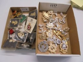 Two trays of assorted military badges and buttons,