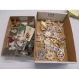 Two trays of assorted military badges and buttons,