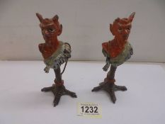 A pair of Austrian Devil candlesticks (one horn on each devil is missing or damaged).