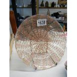 An unusual glass plate with interwoven features.