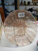 An unusual glass plate with interwoven features.