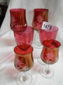Six cranberry glasses including four engraved.