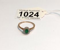 An 18ct yellow gold diamond and emerald ring, size S, 2.2 grams.