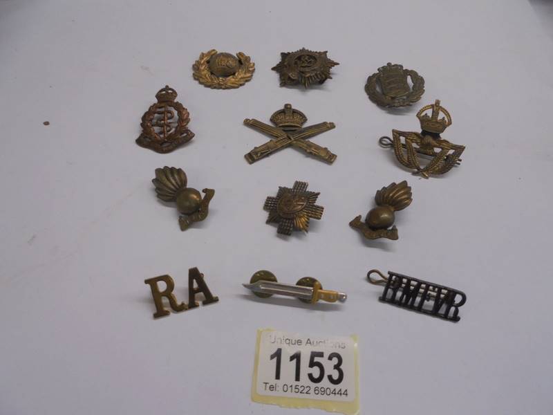 A quantity of military cap badges including Royal Army Medical Corps.