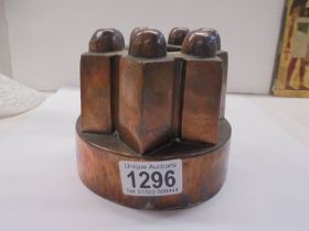 A Victorian copper jelly/cake mould, 11 cm deep x 13 cm diameter.