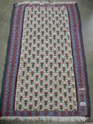 A 70 x 110 cm patterned reversible rug.