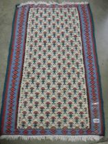 A 70 x 110 cm patterned reversible rug.