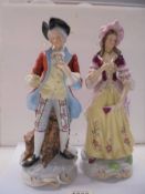 A pair of 19th century ceramic figures, 29 cm tall.