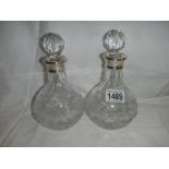 A pair of good cut glass decanters with hall marked silver collars.