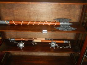 A collection of replica ornamental weapons being two flails and a battle axe