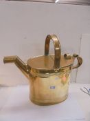 A large brass watering can.