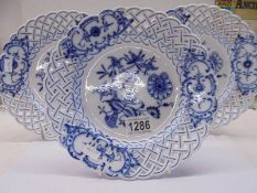 Three Meissen blue and white plates with reticulated borders.