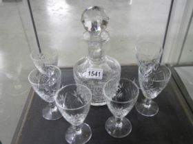 A cut glass decanter and six glasses.