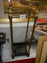 An early 20th century brass and cast iron umbrella/stick stand.