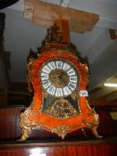 An early brass mounted birds eye mantel clock in working order.