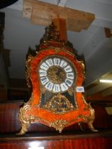 An early brass mounted birds eye mantel clock in working order.