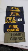 An original WW2 home guard arm band and four fire guard arm band of indeterminate age.