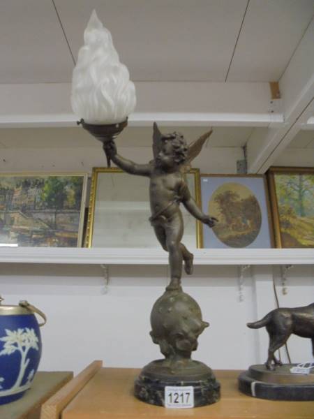 A Cherub table lamp with flame shade.