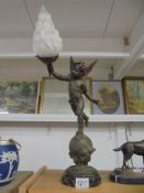A Cherub table lamp with flame shade.