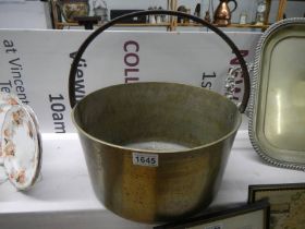 A very large brass jam pan.