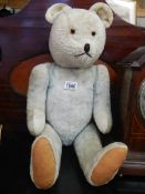 An early 20th century Teddy bear with growler.