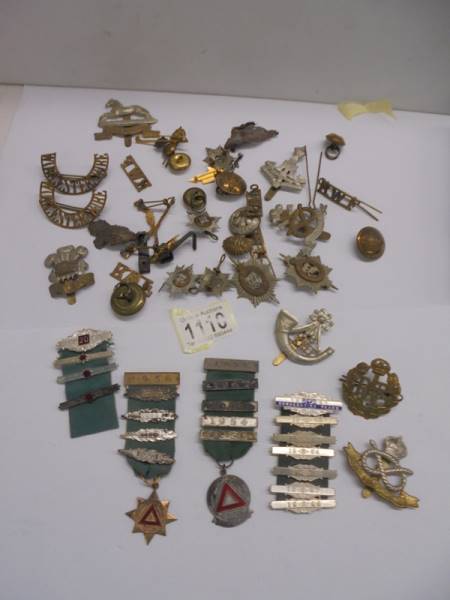 A mixed lot of military medal bars, badges and buttons.