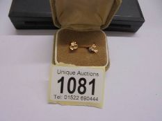 A pair of 9ct gold stud earrings.