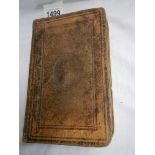 A 19th century copy of the New Testament, back cover distressed.