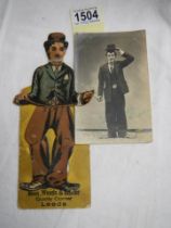 A Charlie Chaplin advertising card and a signed Charlie Chaplin photograph.