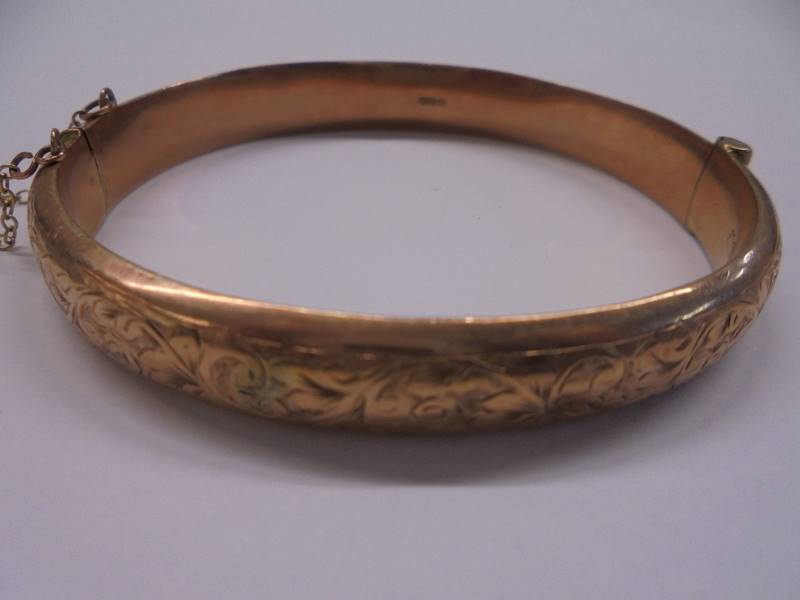 A 9ct gold engraved bangle, 10.7 grams. - Image 2 of 2