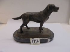 A bronze labrador on a marble base.