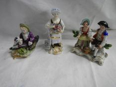 A Crown Derby figure and two other porcelain figures.