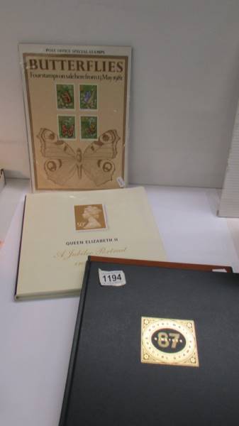 A 1987 Royal Mail stamp book, A Queen Elizabeth II Portrait in Stamps book & set of butterfly stamps