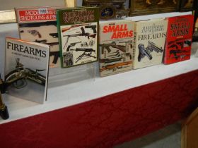 Seven hard back books relating to fire arms etc.,