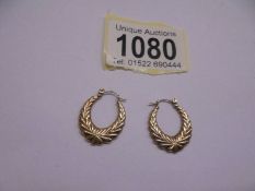 A pair of 9ct gold fancy design ear hoops.