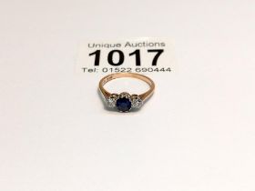 An 18ct gold diamond and sapphire ring, size K half, 2.4 grams.